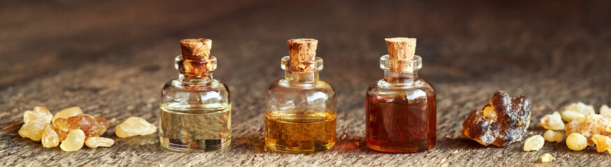 Bottles of aromatherapy essential oil with frankincense or boswellia resin - panoramic header