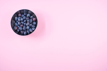 organic fresh blueberries in a metallic bowl on a pink background - Powered by Adobe
