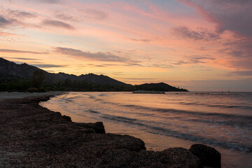 Fototapeta premium The beach at Saint Florent Corsica France at sunset with mountains in the background . holiday destination ..