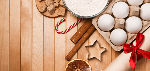 Top view on christmas flatlay of ingredients for baking cookies. Eggs,flour,cinnamon,sugar, star shaped form. Mockup