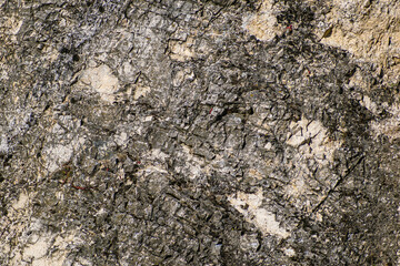 Rough crumbling surface stone texture dark background