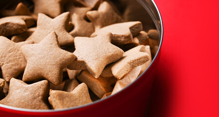 A box of homemade cookies shaped as stars against red background. Mockup