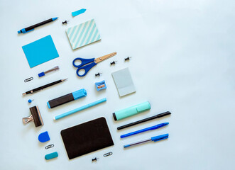 Top view of blue stationery in symmetry with blank sticky notes. Flat lay of school and office supplies for planning and writing. Organize blue accessories for students with copy space