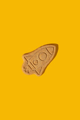 Pattern of cookies in the form of a rocket on a yellow background.