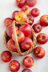 Red apples in a basket on a white background