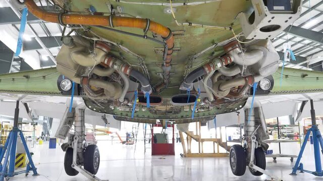 View Of Pressurization Air Conditioning Kit (PACK) Under An Aircraft In Maintenance At The Hangar. low angle, tilt down, 4k