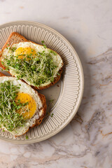Fried egg sandwich with microgreens.