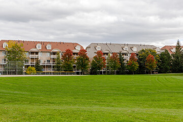 Residential houses near park with green lawn and trees in Ottawa city of Canada