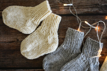 Chunky and warm handmade woolen socks on dark wooden background 