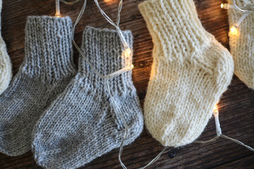 Chunky and warm handmade woolen socks on dark wooden background 