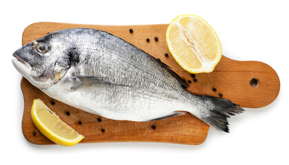 Raw dorado with lemon on a kitchen board on a white background. Isolated