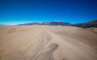 Fototapeta na wymiar Looking down a ridge of a sand dune