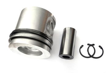 Piston, piston pin and locking ring on an isolated white background. New spare parts.