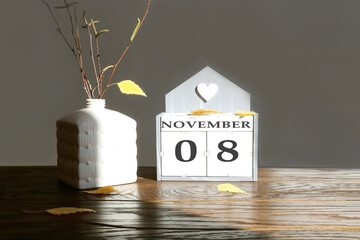 Calendar for November 8: name of the month in English, numbers 0 and 8 birch branch with one yellow...