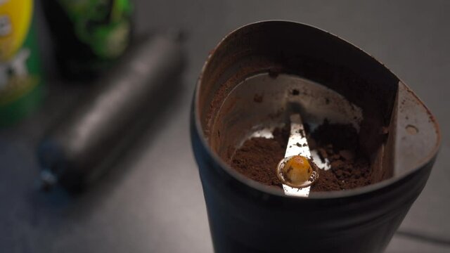 Closeup abstract shot of coffee beans pouring into a grinder with black pudding sausage