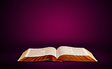 The book is reflected in the table as a symbol of bible. Concept - reading christian literature.