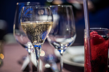 a glass of champagne on the table in the wedding banquet