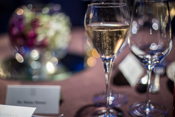 a glass of champagne on the table in the wedding banquet
