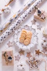 Fototapeta na wymiar Christmas time, homemade cookies with ornaments and winter decorations in white