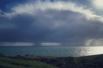 storm clouds over the sea with lighthouse