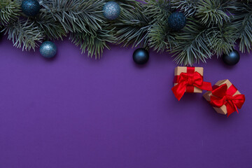 Fototapeta na wymiar Christmas tree branch decorated with Christmas balls. New Year card, top view, flat lay.