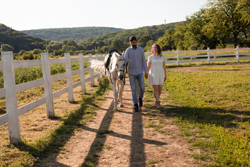 Couple walk at the ranch during summer day