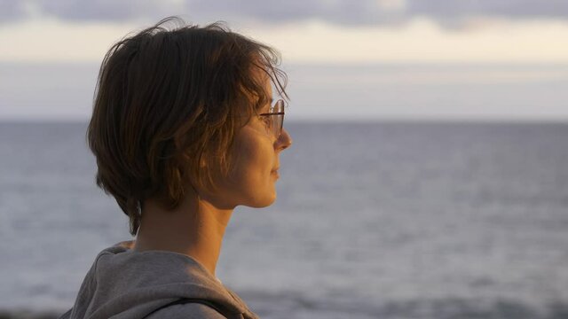 Woman Enjoying the Sunset alone on the Beach