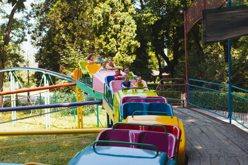 The happy little children are resting in the amusement park