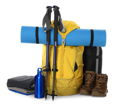 Trekking poles and other hiking equipment on white background