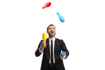 Happy businessman juggling with clubs