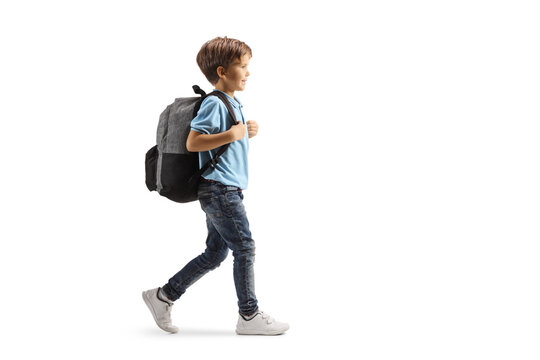 Full length profile shot of a boy with a backpack walking