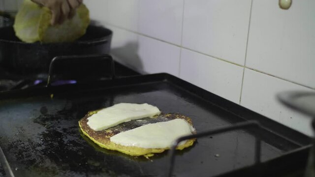 Preparation of a Traditional Venezuelan Dish, Sweet Corn Crepe Cachapa Filled with Cheese