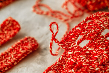 Crocheting a mesh bag with red white threads. Zero waste concept.