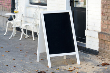 Signboard on the street. Empty menu board stand. Restaurant sidewalk chalkboard sign board....