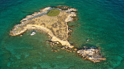 Fototapeta na wymiar Aerial drone top down photo of small tropical exotic island covered in limestone with emerald sea