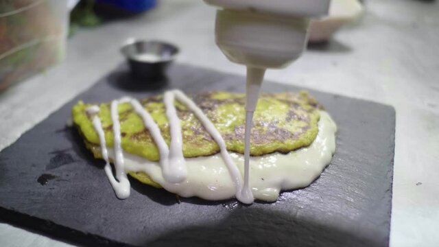 Preparation of a Traditional Venezuelan Dish, Sweet Corn Crepe Cachapa Filled with Cheese