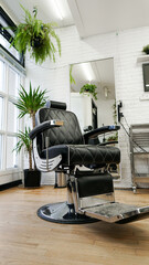 Barber chair sitting inside of a Barbershop. 