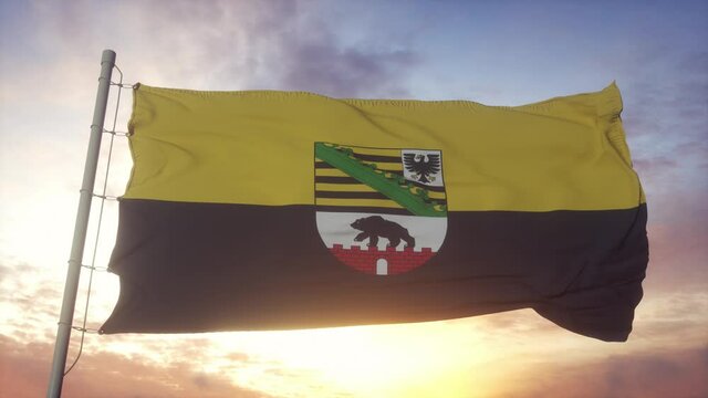 Saxony-Anhalt flag, Germany, waving in the wind, sky and sun background