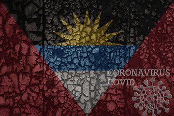 flag of antigua and barbuda on a old metal rusty cracked wall with text coronavirus, covid, and virus picture.