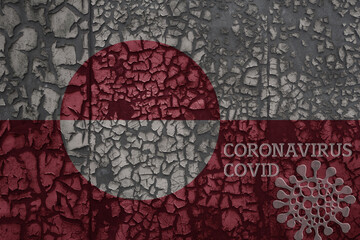 flag of greenland on a old metal rusty cracked wall with text coronavirus, covid, and virus picture.