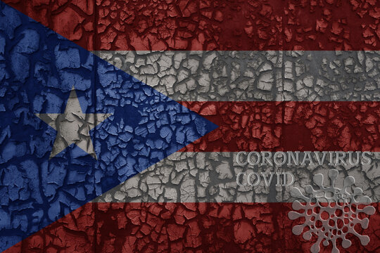 flag of puerto rico on a old metal rusty cracked wall with text coronavirus, covid, and virus picture.