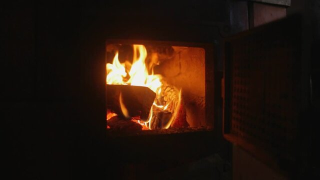 Putting Wooden Logs Into Fireplace at winter