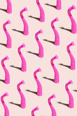 Minimal pattern made of funky pink colored elephant trunks. Baby pink background.