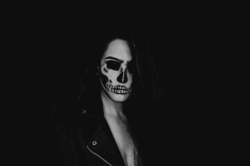 A girl with skull make up. Halloween happy party.