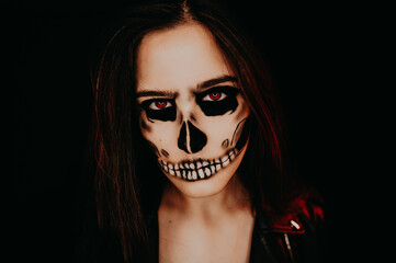 A girl with skull make up. Halloween happy party.