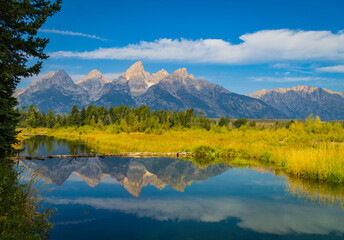 beautiful reflection of the Grand Teton Mountain Range in the water near Schwabacher Landing on the Snake River in Wyoming
