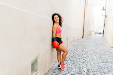 Fototapeta premium Woman power, self defence concept. Portrait of attractive serious fit boxer, ready for fight