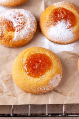 homemade cookies with orange jam lies on cooking paper
