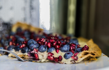 Pie with blue berries and pomegranate