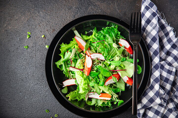 crab stick salad green lettuce leaves mix fresh meal snack on the table copy space food background rustic. top view keto or paleo diet 